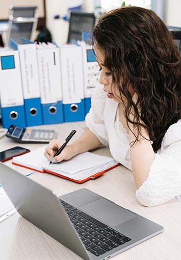 Woman manages records at work on a computer