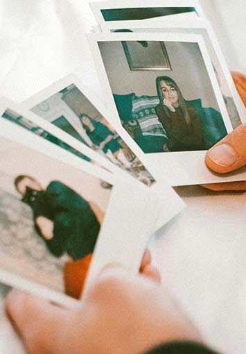 Man holding several photographs ready to scan them